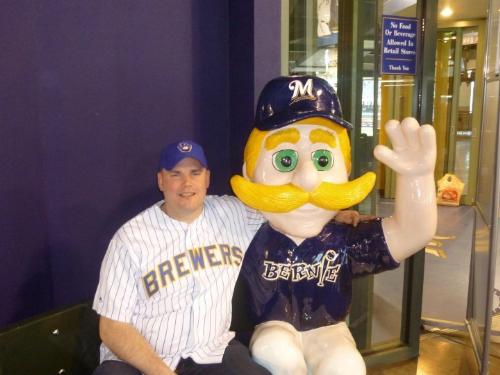 fan with Brewer Mascot - This is my friend Justin at Miller PArk posing with a statue of Bernie Brewer,the Brewers mascot.