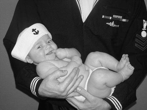 MY son at 3 months - I took this photo of my son at 3 months with his Dad in his uniform. My Mom had gotten my son this hat and I thought this would be to cute. Its still one of my favs.