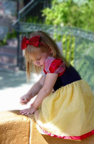 My daughter as Snow White - We took my daughter one year when she was two and I had her dressed as Snow White. I had t get a pic of her making a wish in Snow Whites fountain.