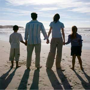 a family with children - an image of a family on a beach with two children for this category