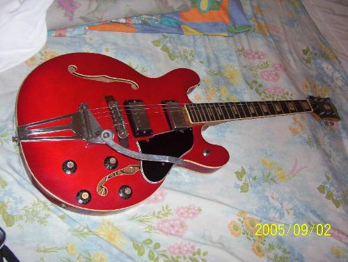 guitar - A vintage red guitar with spoon vibrola bar