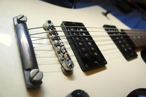 guitar - A white guitar with black electronic.