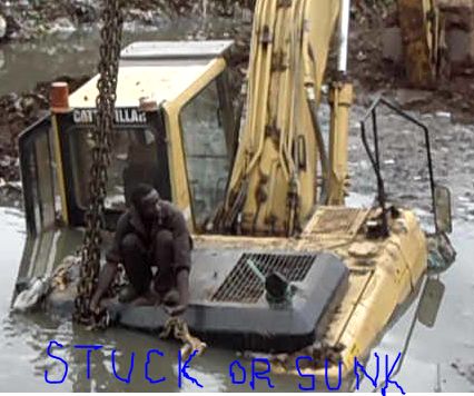 sinking  - An earth digger stuck and sunk in a small river