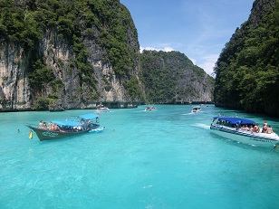 Koh Phi Phi, Thailand - This photo shows the gorgeous bays around Koh Phi Phi, Thailand. It is a truly stunning island with fantastic limestone cliffs and crystal clear blue water!