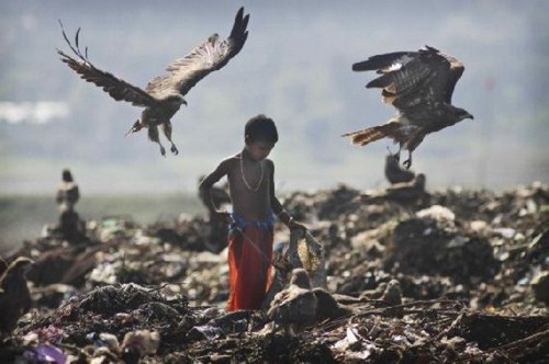 Childhood. - A street child searches for recyclable material in a garbage dump on the outskirts of Gauhati, India, Thursday, Nov. 19, a day ahead of Universal Children’s Day.
