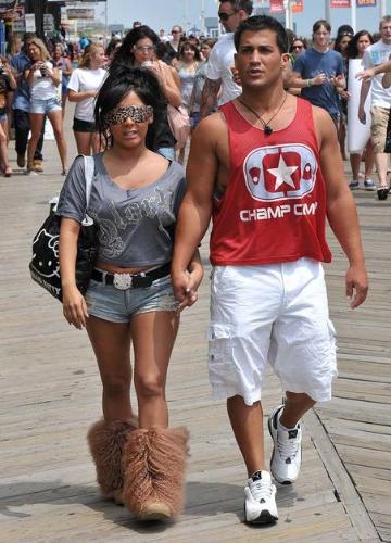 Snookie - She looks weird in those spotted sunglasses and big foot boots! Boyfriend looks hot,though!