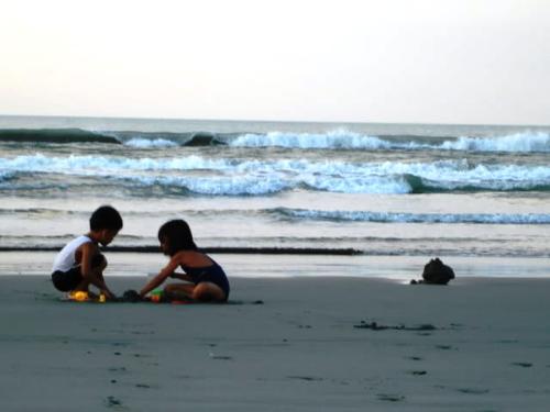 kids - picture of kids playing at the shore befor tsunami warning in Philippines.