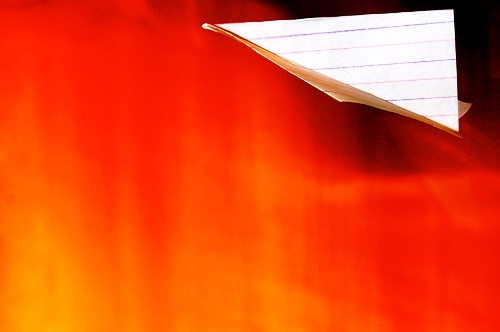 paper - a paper plane editied to have red background, almost orangey