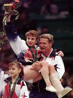 helping hand - In 1996 Summer games in Atlanta,USA gymnist Kerry Scruggs won the gold in the woman's vault on a bad leg! Coach Bela Karoli is giving her a left here!