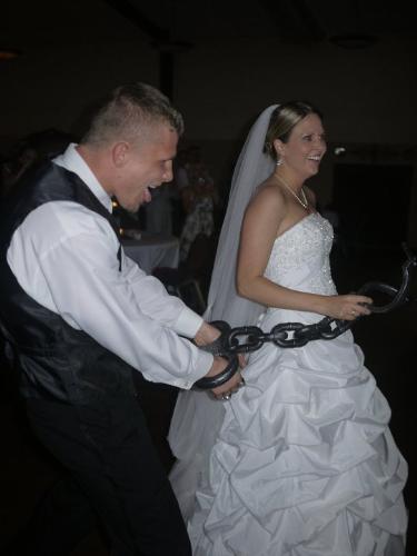 John and sarah - A month ago my friends John and Sarah got married. During the wedding someone put huge hand cuffs on John and Sarah was leading him around! Usually someone puts a ball and chain around the guys leg! I will tell you nthis,Sarah does wear the pants in the marriage! Big time!