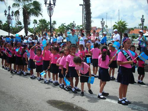 Flag parade in Aruba - All schools parade, even the tiny children. They look cute with their national flag.