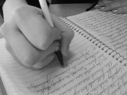 Writing - Someone writing in a notebook.