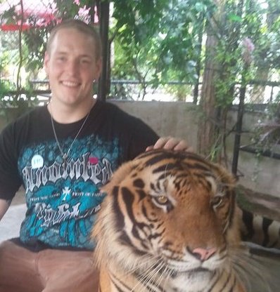 Dan and the Tiger - My nephew Dan has shore leave from the Navy in Thailand last weekend. He was able to meet a tiger at a tiger zoo! I would be scared to get that close to a tiger but Dan had the privelage to!