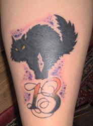 Halloween Tattoo - This is a Halloween tattoo with a Black cat and the number 13.  13 is one of those things that you see a lot in superstition and in tattoos.  Along with Lucky number 7
