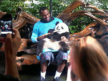 LeBron James - LeBron James in China at the Panda sanctuary. He was able to hold ans feed a baby panda!
