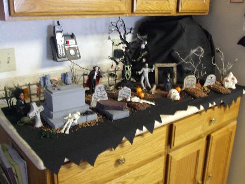 Counter-top Cemetery - Many pieces here were crafted by me. It was fun making the tombs, painting and glue pieces together. I bought the characters though. 