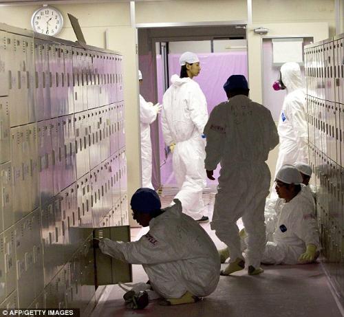 Fukushima Dai Ichi Nuclear Power Station Workers - Ending a long shift: Workers in protective suits gather near their lockers inside the emergency operation center at the crippled Fukushima Dai-ichi nuclear power station in Okuma, Japan.
