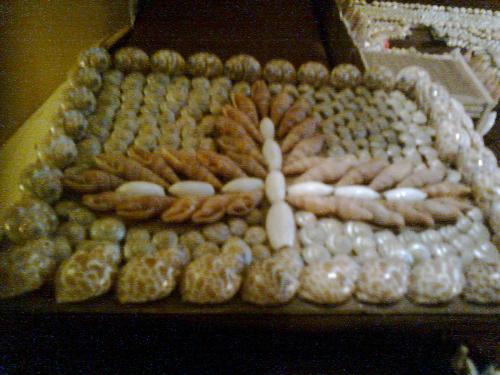 A handmade wall decoration - This is a handmade wall decoration made of sea shells .