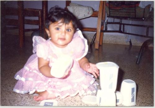 A very cute baby for a proud father like me. - This is a childhood photo of my daughter that we cherish very much. She looks she lively and intent in this photo with a bright pink dress!