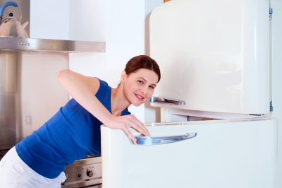 Proud lady with refrigerator (Ambro) - People look for every new appliance that's advertised in store discarding their old ones too often!