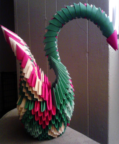 Origami Heart Swan - Created from strips of papers folded into triangles and molded to form a swan with heart patterns.