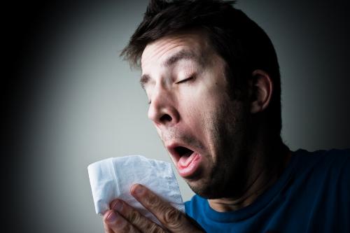 Man sneezing  - Picture of a man sneezing