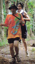 hashers following paper marked trails. - These two persons are walking and jogging following trails marked with paper.