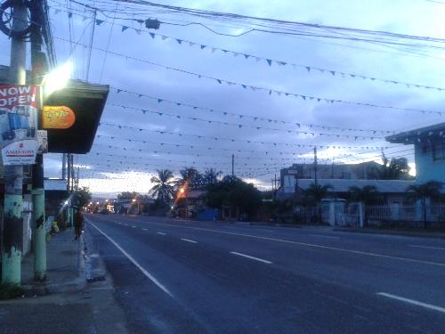 By the Road - This is the time between 5 to 6 am. I am waiting for a bus because I will be going somewhere and the travel hours will take 2 to 3 hours.