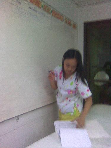 Writing schedules of operation - This is a scene in a government hospital. The nurse is writing the schedule of elective operative procedure in the white board.