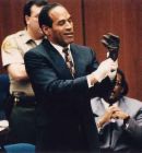 Oj Simpson - Oj Simpson tring on the glove at his trial.