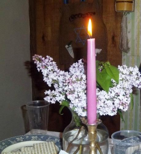 candle and lilacs - This is what my Seder table had as a centerpiece.