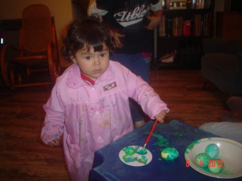 Easter - Baby painting eggs during Easter.