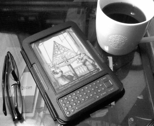 Cup of coffee and a Kindle - cup of coffee a kindle and a pair of eyeglasses