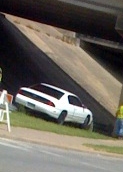 Car on barrier - None of the wheels are on the ground