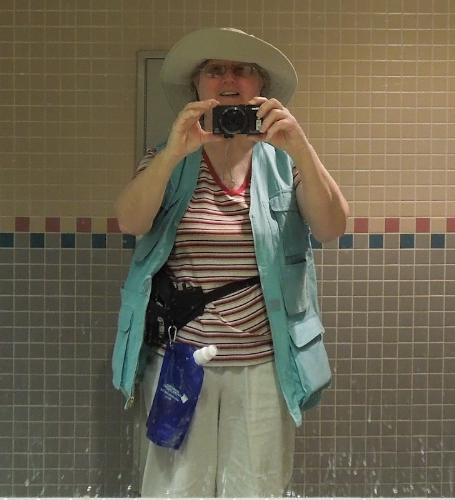 Picture of me, taken by me, dressed to photograph  - I took the picture in the library restroom. I couldn't think of a better way to carry my four cameras, ID, water, something to write on and with, and still have room for all the information I would be collecting from various booths. I know it's not very fashionable or flattering, but it was practical for the occasion. 