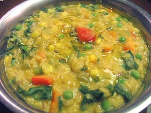 Masala Khichdi - A pressure cooker recipe made up of rice, lentils, vegetables, butter, and various seasonings. It is a pure Gujarati dish and enjoyed in homes almost everyday. It can be had with yogurt, curry, peanut oil [as garnishing] or even by itself.  It is fast to cook and very affordable, as it can be worked with as little or as many ingredients as you want to add and another benefit is that the leftover can be had as breakfast the next day, because it tastes good hot or cold.