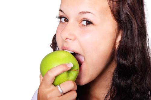 Eating healthy - a woman eating an apple Eating healthy - a woman eating an apple