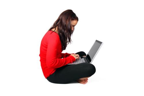 Girl on Laptop - girl sitting looking at a laptop
