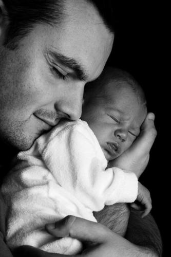 The first Cuddle with your baby - man cuddling his baby for the first time.