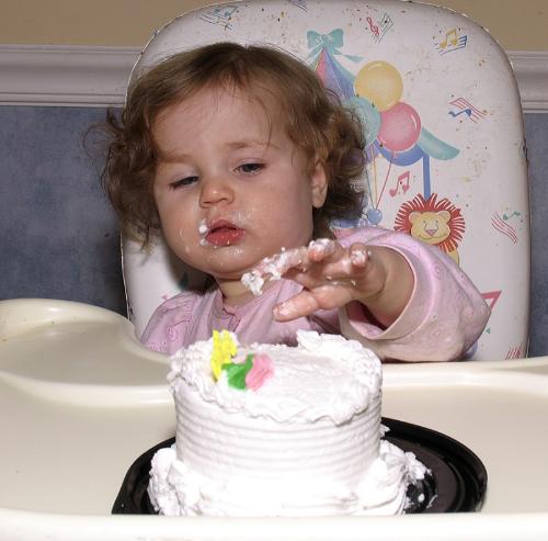 Birthday cake - It looks like this baby is enjoying her first birthday, and is ready to dig into that cake!