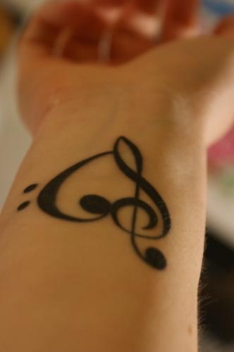 Musical Heart - This is a tattoo of a heart on wrist, where the heart is drawn in such a way as to have a musical note on one side of it.