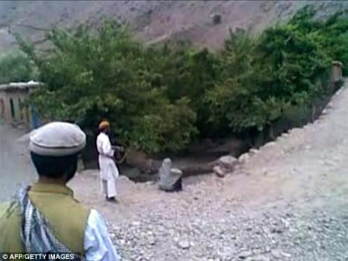 Afghan Woman Gunned due to Taliban Love Triangle - The woman sitting at the edge of the cliff was killed due to two Taliban men who had a relationship with the woman. They instead opted to accuse her of adultery to &#039;save face&#039;. 

The woman was fired on and killed by the man wearing white.