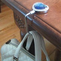Bag Hook - This is an example of a bag hook which you can carry in you bag, then use while in a restaurant when you don't want to be bothered by your bag being on your lap.