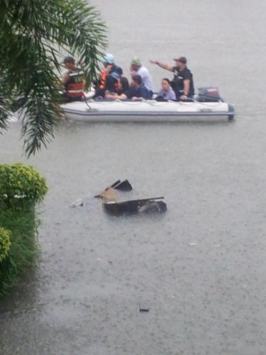 Families being rescued  - The flood rendered many families homeless. Those in the rooftops were evacuated through by wooden or rubber boats.