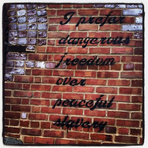 Art? Is it when it is just scribbles? Graffitti? - It is statement. Is it a quote. I really want to know what it means but it really is nice coloring with the brick. I love brick photography.