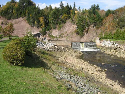 Small dam with a fish ladder. - There is a fish ladder going around this dam probably for salmon on the left side of the picture. Might not be evident from this picture but it is the best picture I had of it. It's located in St. Martin, NB Canada.