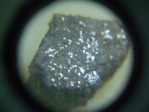 Jilin meteorite metal flakes - This image shows the light reflecting from metal flakes visible on the cut face of the Jilin meteorite.