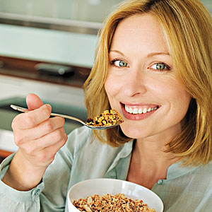 A women eating meals - A women doing two works at time eating meals and laughing 