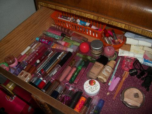 Makeup collection - This is the half of my drawer that is mostly all lip products. My face products are also there because I don't have very many. In the back you can see that I have the chap sticks in a little container and all my small lip glosses in another little container.