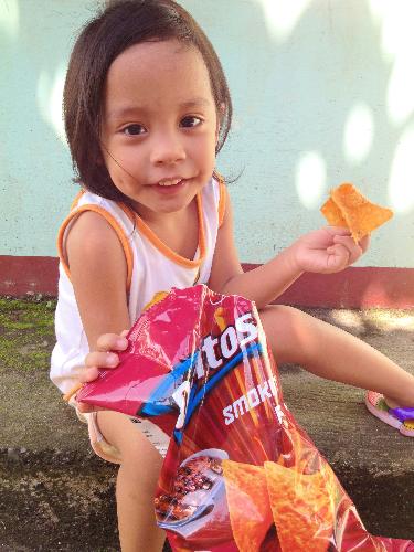 My 3-year-old niece posing with Doritos - My 3-year-old niece posing with Doritos. Just having fun on an afternoon break.